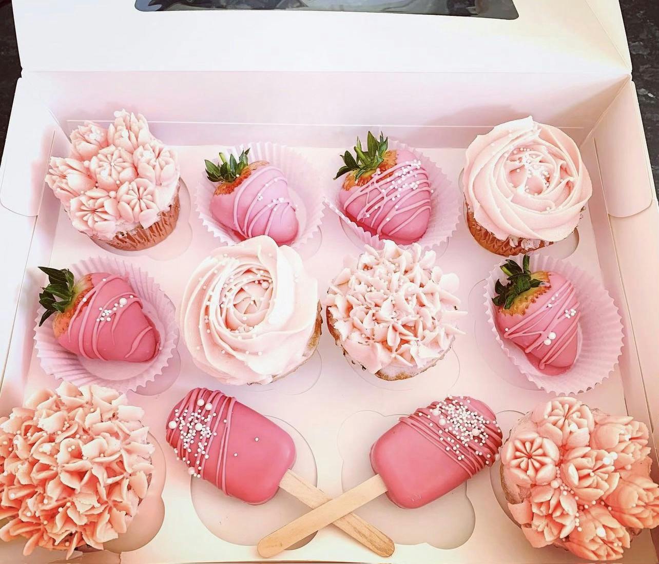 Pink flowery cupcakes, pink cake pops with cake pearls, and pink chocolate covered strawberries