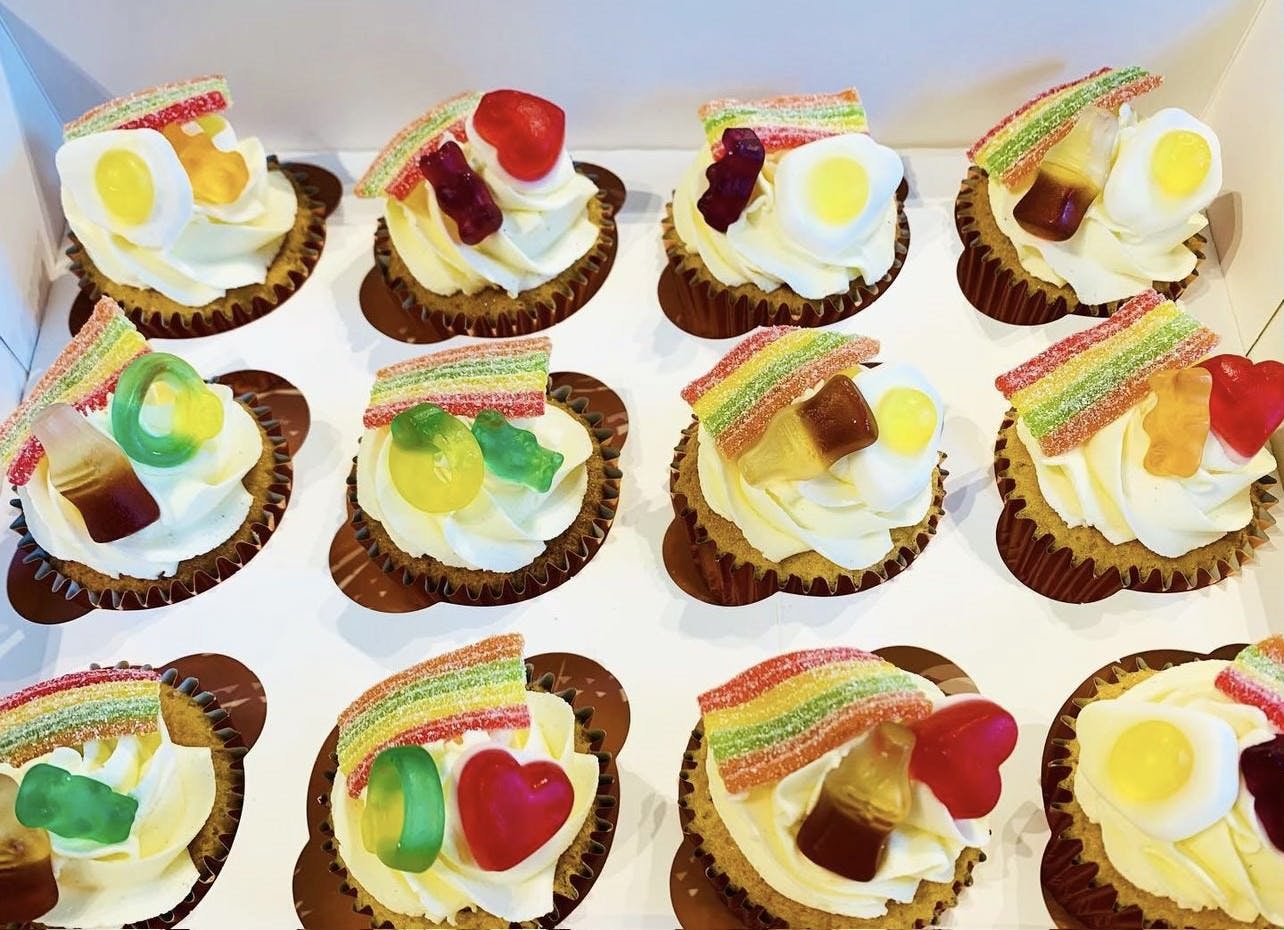 White frosted cupcakes with haribo sweets on top