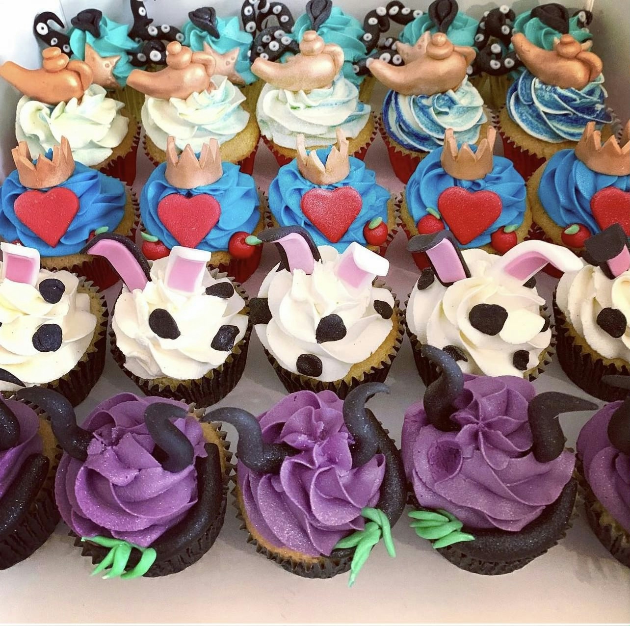 Purple, White and blue cupcakes with decorations on top