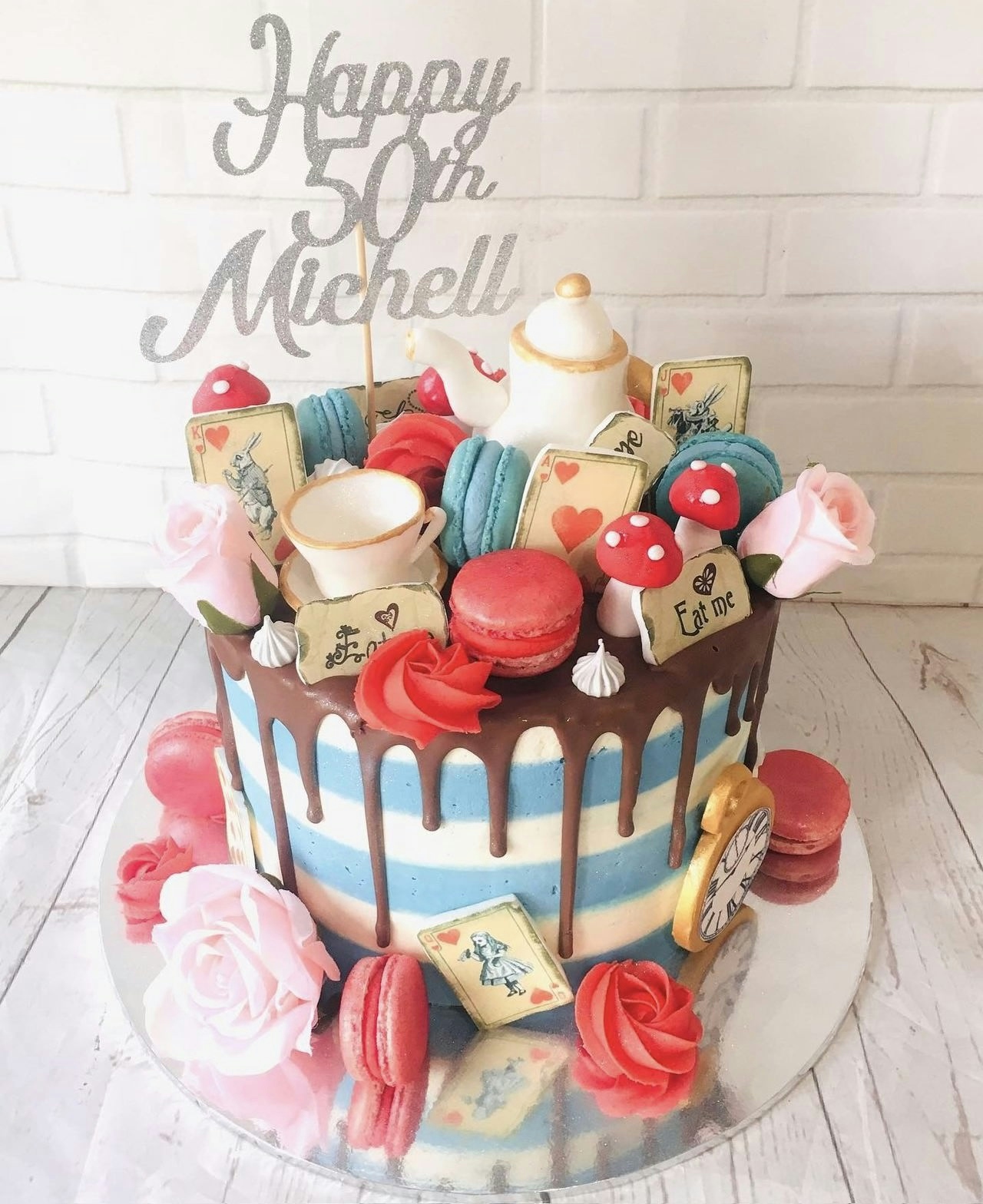 A birthday cake in the style of Alice in Wonderland