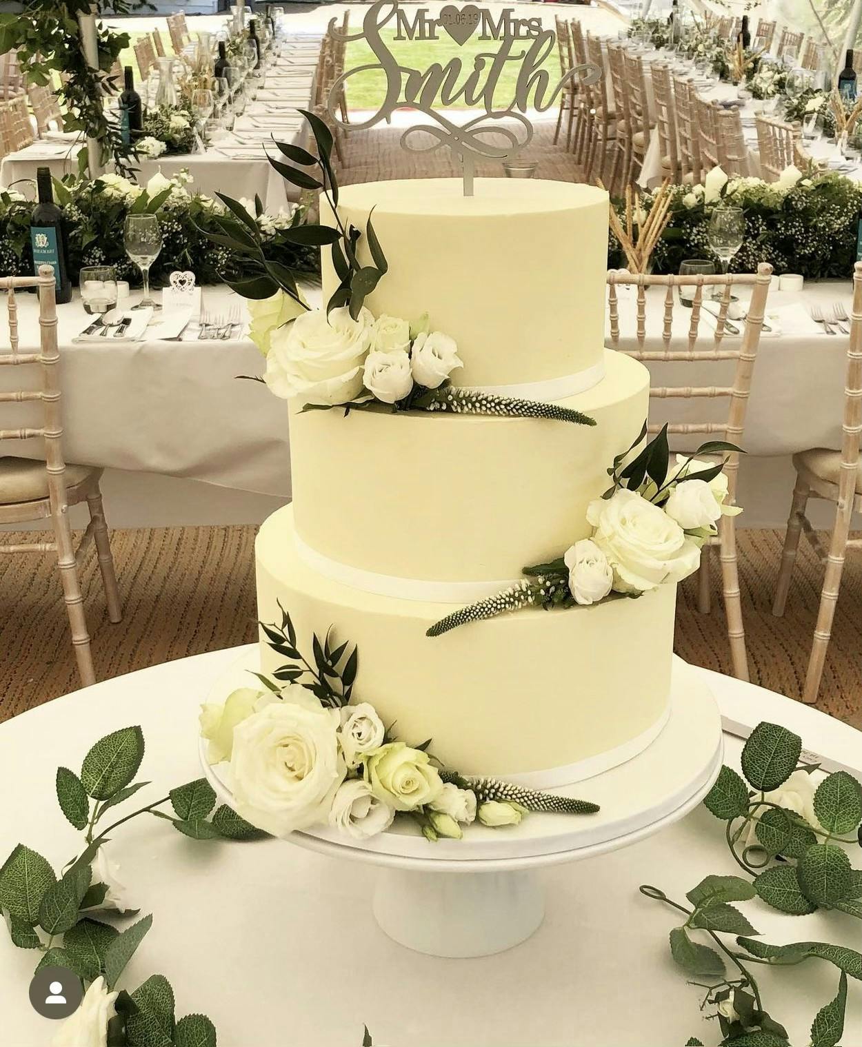 White wedding cake with white flowers and plants for Mr and Mrs Smith
